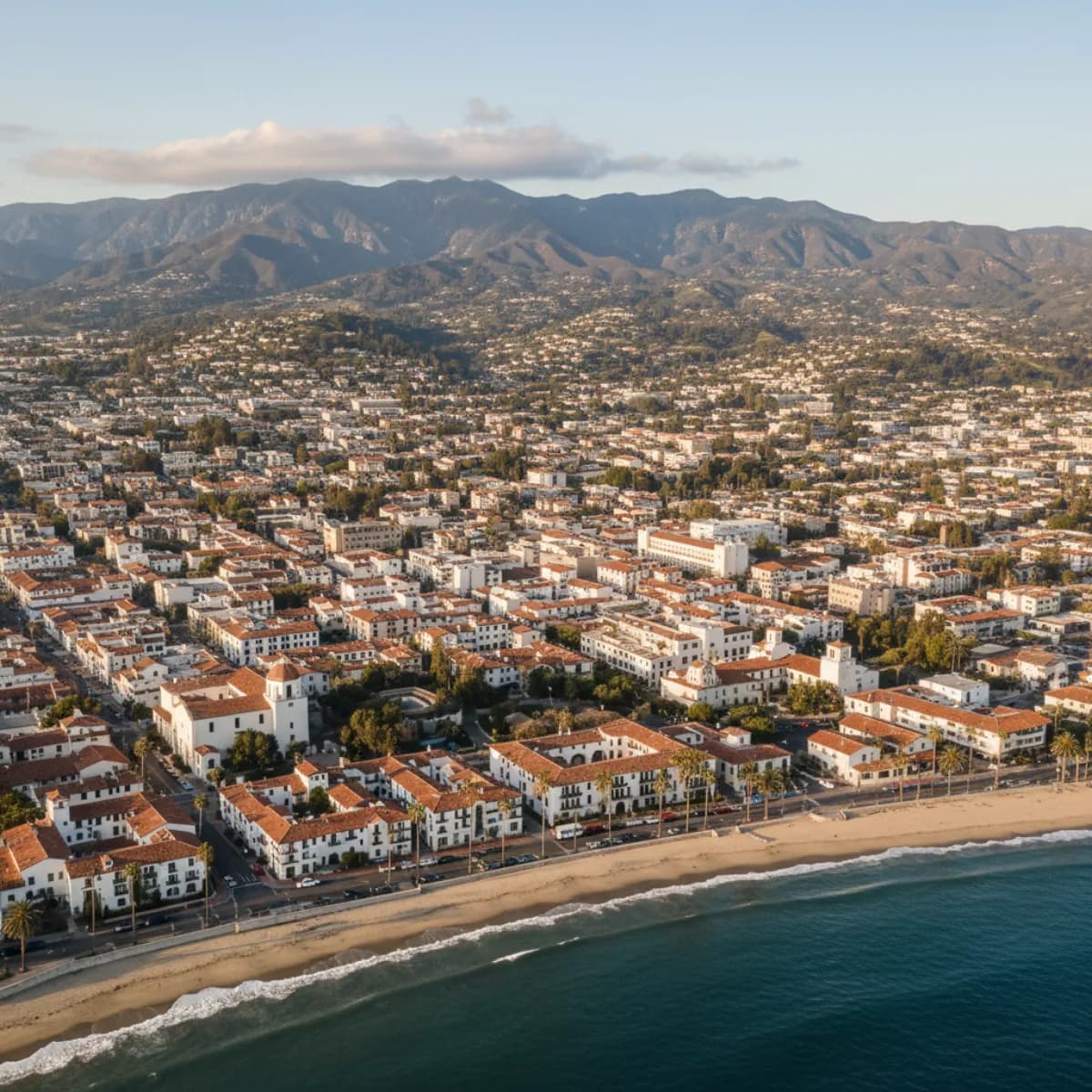 Santa Barbara CA red clay tile rooftops with Pacific Ocean and mountain backdrop